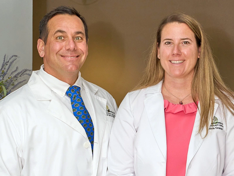 Image of Dr. Davis and Dr. Cramer standing in white coats and smiling.